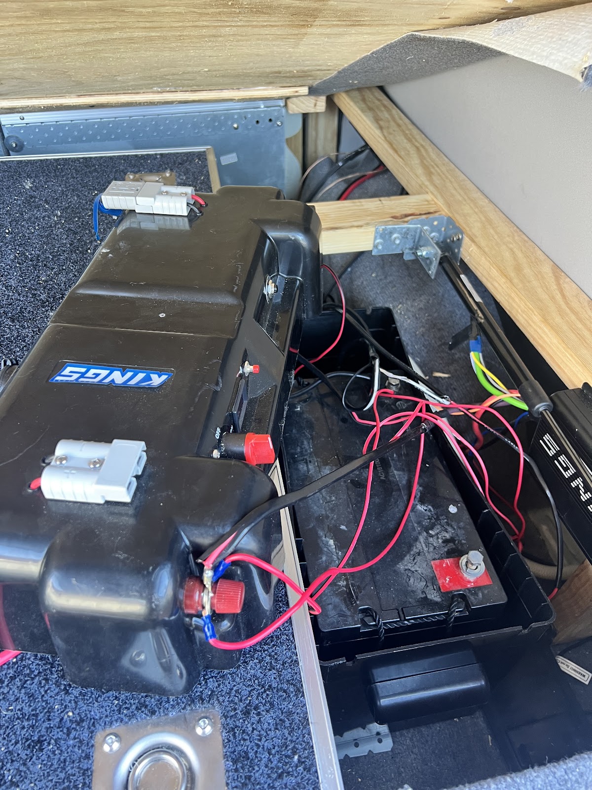 Battery box and wiring installed under a vehicle drawer system