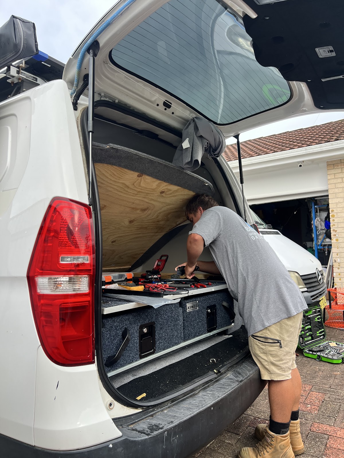 Josh working in the back of a van on a drawer fit-out
